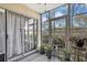 Screened lanai with views of the yard and many potted plants at 12041 Hoosier Ct # 104, Hudson, FL 34667