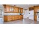 Spacious kitchen featuring custom wood cabinets, granite countertops, and stainless steel appliances at 12603 Corral Rd, Tampa, FL 33626