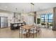 Open-concept living space featuring a dining area adjacent to a modern kitchen at 12785 Jade Empress Loop # 102, Venice, FL 34293