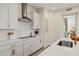 Modern kitchen with white cabinets, stainless steel appliances, and sleek countertops at 12785 Jade Empress Loop # 102, Venice, FL 34293