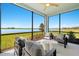 Enjoy the serene water view from the screened lanai with cozy seating at 12785 Jade Empress Loop # 102, Venice, FL 34293