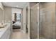 Stylish main bathroom featuring dual vanities, a shower, and an open view to the main bedroom at 12785 Jade Empress Loop # 102, Venice, FL 34293