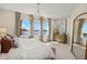 Bright main bedroom featuring large windows with a view, stylish furnishings, and modern decor at 12785 Jade Empress Loop # 102, Venice, FL 34293