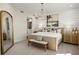 Beautiful main bedroom showcasing a decorative chandelier, ensuite, and a neutral color palette at 12785 Jade Empress Loop # 102, Venice, FL 34293