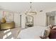 Airy main bedroom showcasing a decorative chandelier, full-length mirror, and neutral color palette at 12785 Jade Empress Loop # 102, Venice, FL 34293