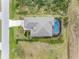 Aerial view of property featuring pool, screened lanai, and well-maintained landscaping at 135 Cabana Way, Rotonda West, FL 33947