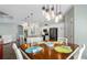 An inviting dining area boasts stylish lighting, seamlessly connecting to the well-appointed kitchen at 135 Cabana Way, Rotonda West, FL 33947