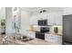 Chic kitchen with white cabinetry, modern appliances, and granite counters, blending style and functionality at 135 Cabana Way, Rotonda West, FL 33947