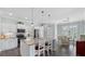 Bright kitchen featuring white cabinets, stainless steel appliances, and a breakfast bar with seating at 135 Cabana Way, Rotonda West, FL 33947