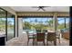 Outdoor lanai featuring a dining set and view of the pool provides a picturesque setting for enjoying the outdoors at 135 Cabana Way, Rotonda West, FL 33947