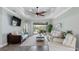Comfortable living room showcases a tray ceiling, stylish furnishings, and sliding glass doors to outdoor living at 135 Cabana Way, Rotonda West, FL 33947