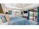 A bright main bedroom with white furniture, a tray ceiling, and access to lanai creates a luxurious space at 135 Cabana Way, Rotonda West, FL 33947