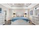A bright main bedroom with white furniture and tray ceilings provides a restful and elegant retreat at 135 Cabana Way, Rotonda West, FL 33947