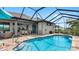 Enjoy the screened-in pool with outdoor shower, palm trees, and a seating area, perfect for relaxation at 135 Cabana Way, Rotonda West, FL 33947