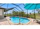 Inviting pool with a screen enclosure offering scenic views of the surrounding landscape at 135 Cabana Way, Rotonda West, FL 33947