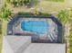 An aerial shot of a screened-in pool, with nice pavers and lounge chairs at 135 Cabana Way, Rotonda West, FL 33947