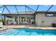 Screened-in pool area with brick pavers, outdoor seating, and dining near the home's open living space at 135 Cabana Way, Rotonda West, FL 33947