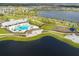 Aerial view of community amenities including pool, clubhouse, playground, and scenic walking paths at 13908 Artesa Bell Dr, Riverview, FL 33579