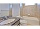Modern bathroom with a granite countertop and a tiled shower/tub combo at 13908 Artesa Bell Dr, Riverview, FL 33579