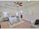 Bright bedroom featuring neutral colors, new furniture, a ceiling fan, and natural light at 13908 Artesa Bell Dr, Riverview, FL 33579