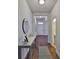 Inviting foyer with hardwood floors, a decorative table, and a view of the front door at 13908 Artesa Bell Dr, Riverview, FL 33579