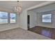 Bright living room featuring a chandelier, natural light from large windows and vinyl and carpet flooring at 13908 Artesa Bell Dr, Riverview, FL 33579