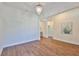 Bright living room with hardwood floors, an elegant chandelier, and an open layout at 13908 Artesa Bell Dr, Riverview, FL 33579