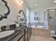 Beautiful bathroom features double sink vanity, soaking tub, and walk-in shower with neutral tile at 13908 Artesa Bell Dr, Riverview, FL 33579