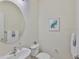 Stylish powder room with a round mirror, modern fixtures, and neutral decor at 13908 Artesa Bell Dr, Riverview, FL 33579