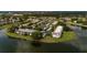 Aerial view of a community surrounded by ponds and mature trees at 142 Lakeview Way # 142, Oldsmar, FL 34677