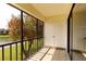 Balcony overlooking lake with view of mature landscaping and a storage closet at 142 Lakeview Way # 142, Oldsmar, FL 34677