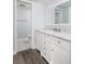 Bathroom featuring white cabinets, marble countertop, and access to the shower and toilet at 142 Lakeview Way # 142, Oldsmar, FL 34677