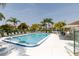 Sparkling community pool surrounded by lush landscaping and comfortable lounge chairs at 142 Lakeview Way # 142, Oldsmar, FL 34677
