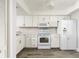 Updated kitchen featuring white cabinets, appliances, and plenty of countertop space at 142 Lakeview Way # 142, Oldsmar, FL 34677