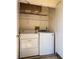 Bright laundry room featuring a newer washer, dryer, wire shelving, and ample space for storage at 142 Lakeview Way # 142, Oldsmar, FL 34677