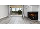 Bright living room featuring a fireplace, balcony access, and scenic lake views at 142 Lakeview Way # 142, Oldsmar, FL 34677