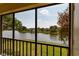 Screened lanai view overlooking a serene lake and lush landscaping, offering a peaceful outdoor retreat at 142 Lakeview Way # 142, Oldsmar, FL 34677