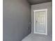 Entryway featuring a gray door with white trim and a doorbell at 14446 Editors Note St, Ruskin, FL 33573