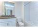 Bright bathroom with a granite countertop vanity and shower over tub with white subway tile surround at 14477 Editors Note St, Ruskin, FL 33573