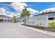 Exterior view of the 'Townes at Belmont' community entrance under a blue sky at 14477 Editors Note St, Ruskin, FL 33573