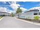 Exterior view of the 'Townes at Belmont' community entrance under a blue sky at 14477 Editors Note St, Ruskin, FL 33573
