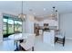Eat-in kitchen area with stainless steel appliances, a breakfast bar, and sliding glass doors at 14477 Editors Note St, Ruskin, FL 33573