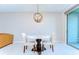 This dining area has a modern chandelier, a small table, and sliding glass doors at 14477 Editors Note St, Ruskin, FL 33573