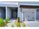 This townhome features a one-car garage, a covered entry, and rock landscaping at 14477 Editors Note St, Ruskin, FL 33573