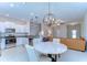 Bright open kitchen featuring white cabinets, stainless steel appliances, granite countertops, and an adjacent dining area at 14477 Editors Note St, Ruskin, FL 33573