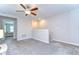 Upstairs loft area with neutral carpeting, ceiling fan, and access to additional rooms, perfect for relaxation or recreation at 14477 Editors Note St, Ruskin, FL 33573