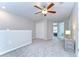 Spacious upstairs loft with cozy carpeting, ceiling fan, and a closet, offering flexible living space at 14477 Editors Note St, Ruskin, FL 33573