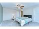 Main bedroom featuring a ceiling fan, soft carpet, and a serene atmosphere, ideal for relaxation and comfort at 14477 Editors Note St, Ruskin, FL 33573