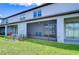 A screened-in back patio with ceiling fan, outdoor seating, and a view of the backyard at 14477 Editors Note St, Ruskin, FL 33573