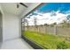 Backyard view from the screened porch, offering peaceful outdoor living with a ceiling fan for added comfort at 14477 Editors Note St, Ruskin, FL 33573